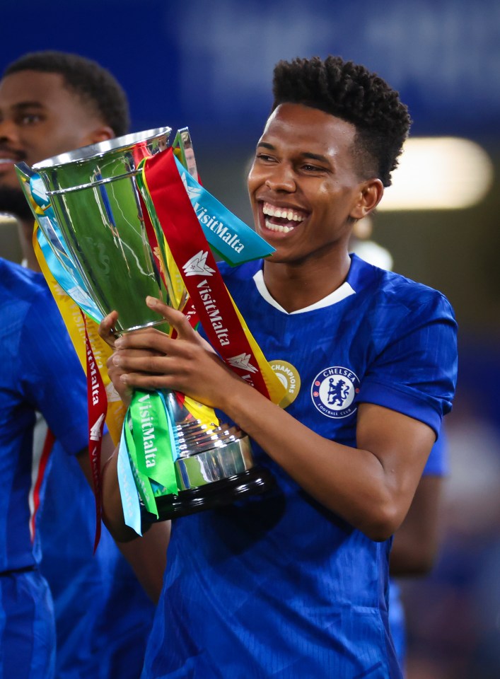Chelsea player holding a trophy.