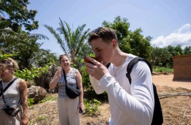 Trying unfermented palm wine straight from the tree (Les Latchman)