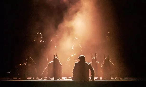 A group of people in silhouette on stage 