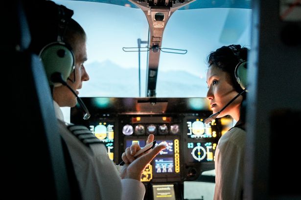 Male and female pilot in the cockpit