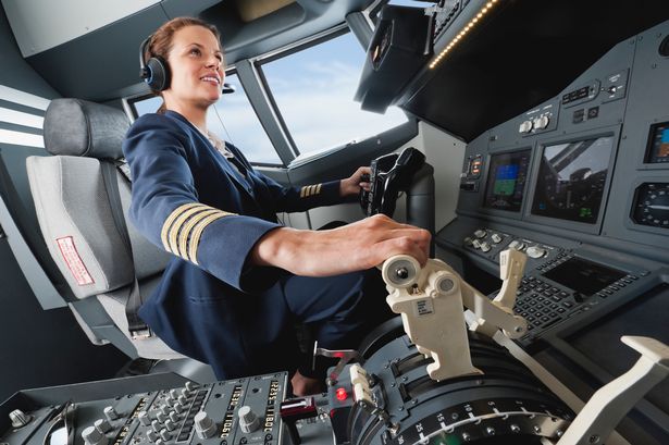 Female flight captain piloting aeroplane from airplane cockpit