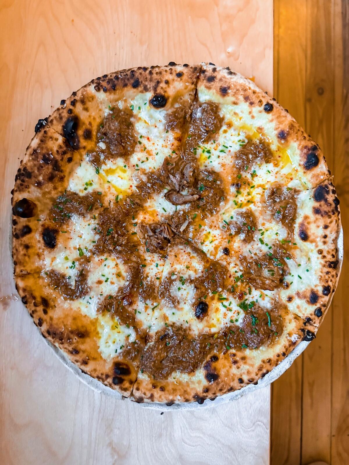 Pizza with duck ragu at Oobatz in Paris
