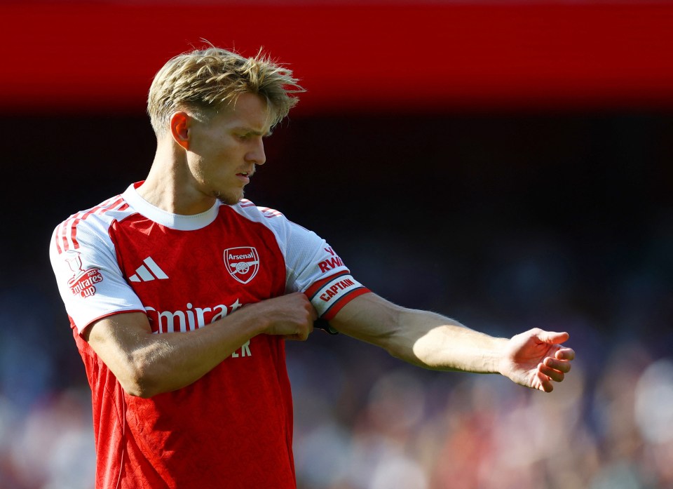 Arsenal's Martin Odegaard adjusts his captain's armband.