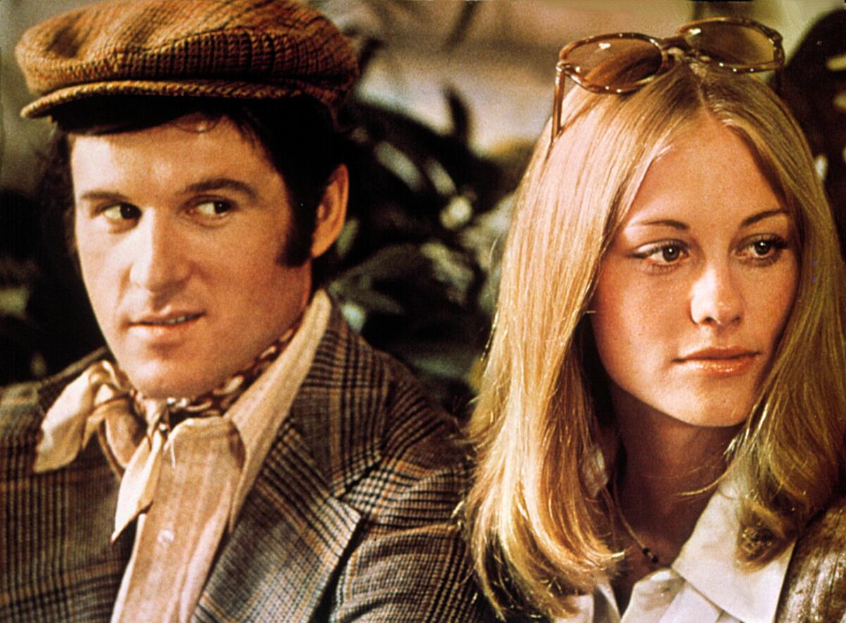 A man sneers at a woman standing next to him.