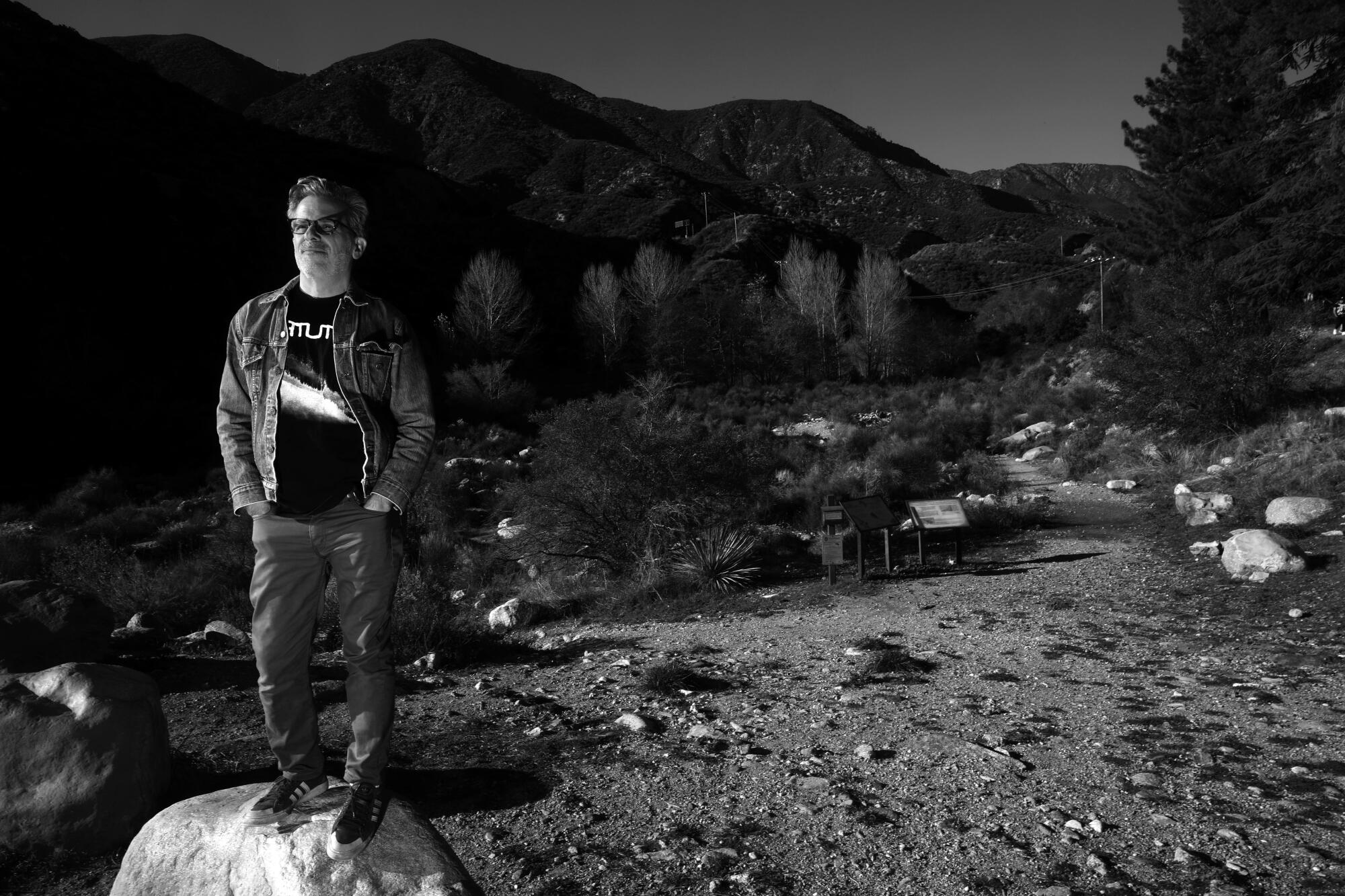 Jonathan Letham stands at the entrance to the Joatngna Trail against a backdrop of Mt. Baldy.