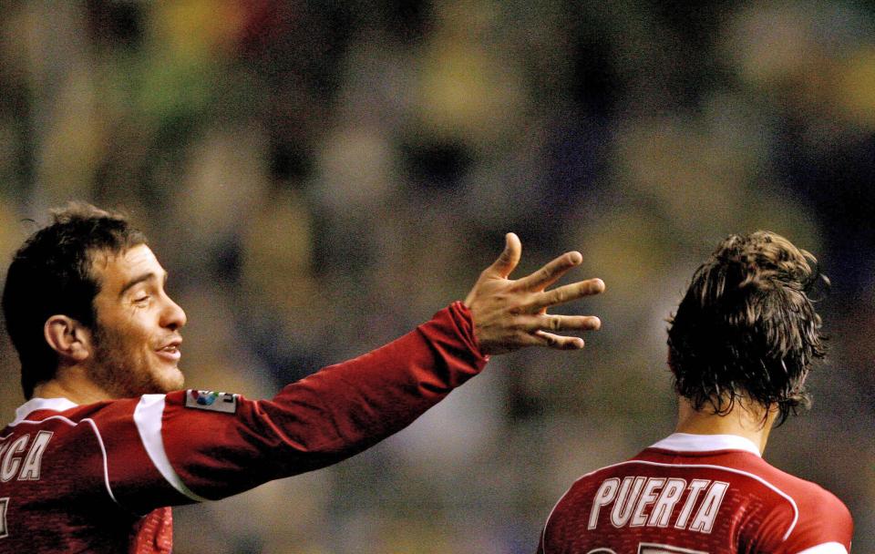 Sevilla's Maresca and Puerta celebrating a goal.
