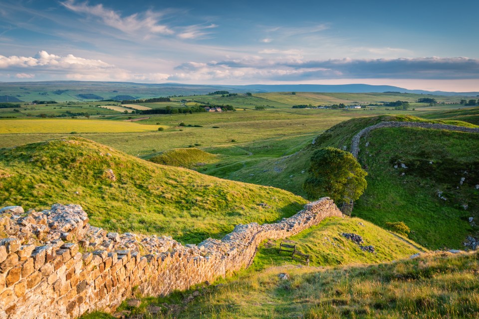 Hadrian's Wall, a UNESCO World Heritage site, winding through a green landscape.