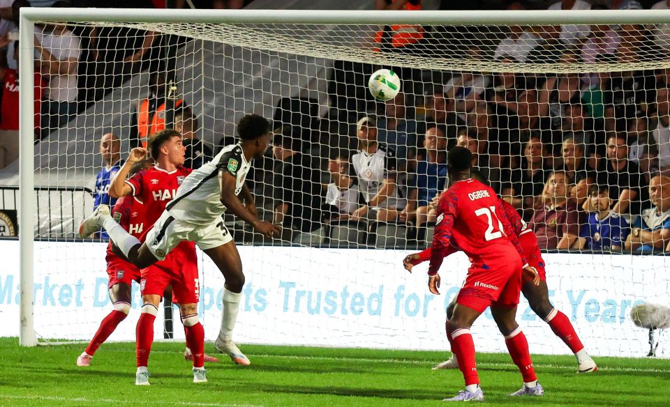 Deji Elerewe of Bromley scores a header goal.
