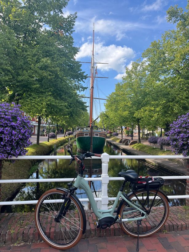A view of a bicycle and ship on the canals in Papenburg