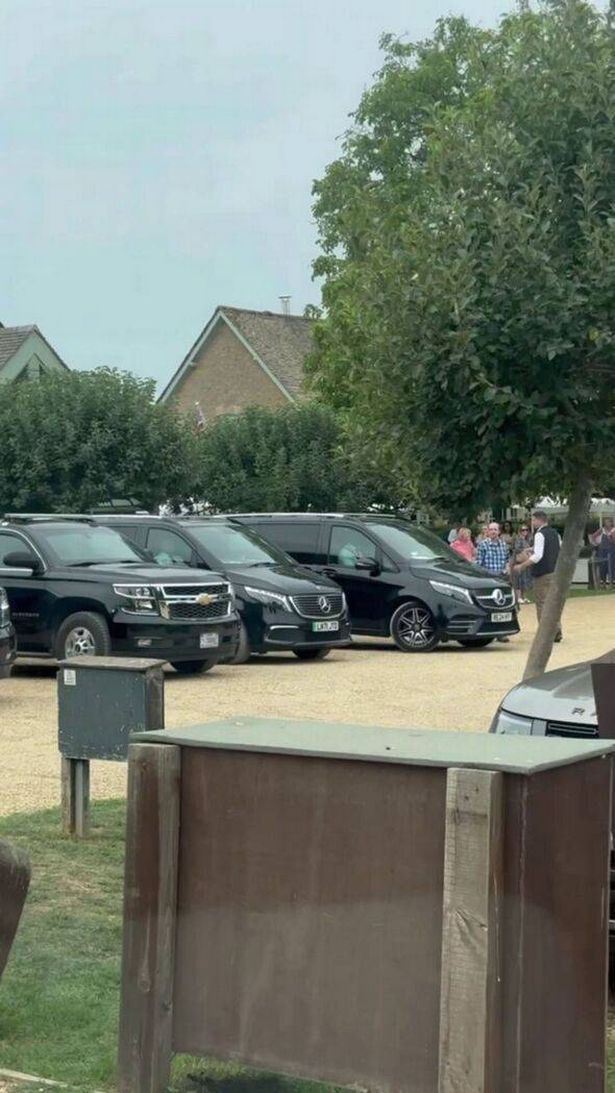 rows of black SUVs at the farm shop for Vance's visit