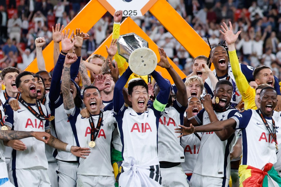 Tottenham Hotspur players celebrating a victory, raising the trophy.