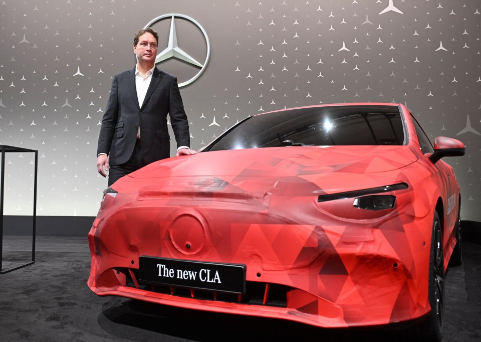 Ola Källenius, CEO of Mercedes-Benz, stands beside a new CLA car.