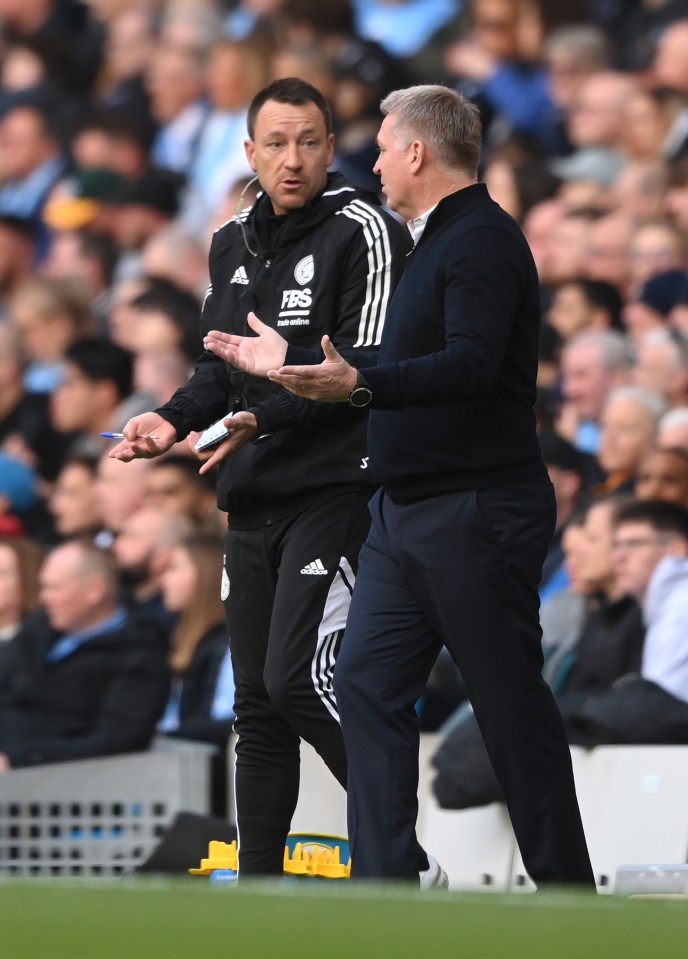 John Terry and Dean Smith, manager of Leicester City, at a soccer match.