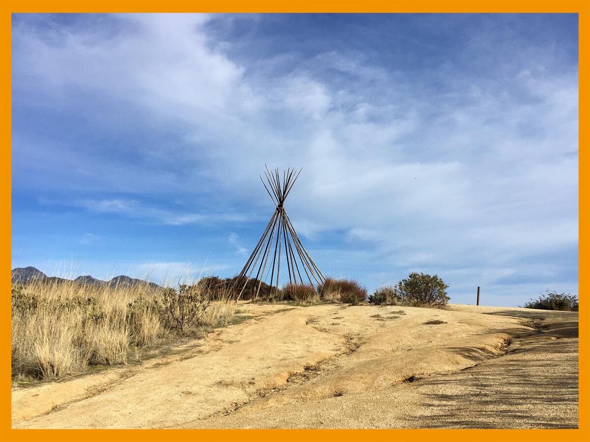 Tee pee at the top of a desert trail.