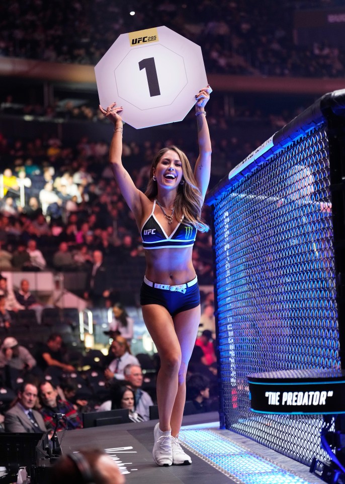 UFC Octagon Girl Brittney Palmer holding up a round 1 sign.