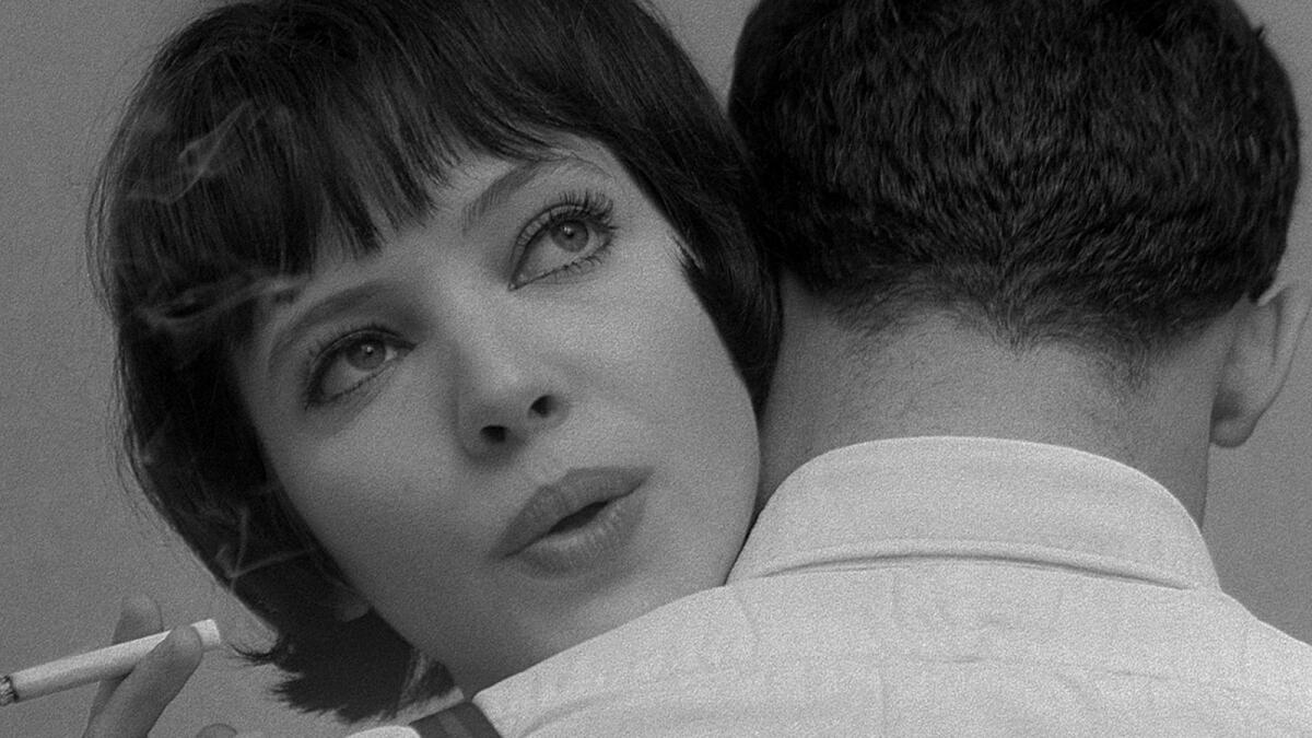 A woman with a dark bob is embraced.
