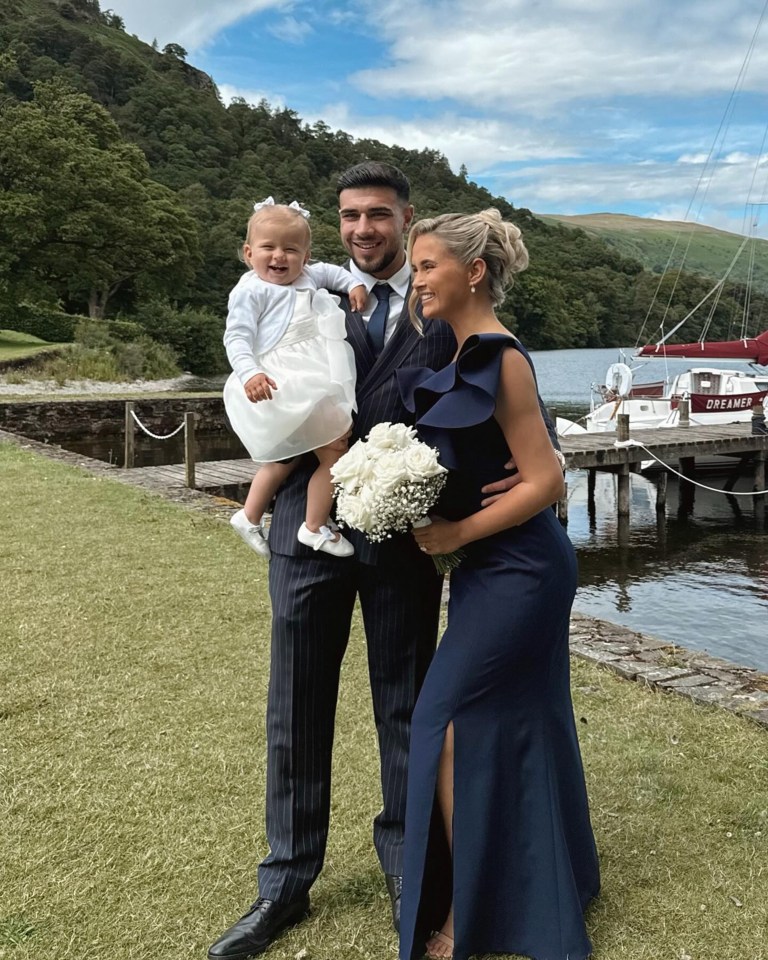 Tommy Fury, Molly-Mae Hague, and their daughter at a wedding.