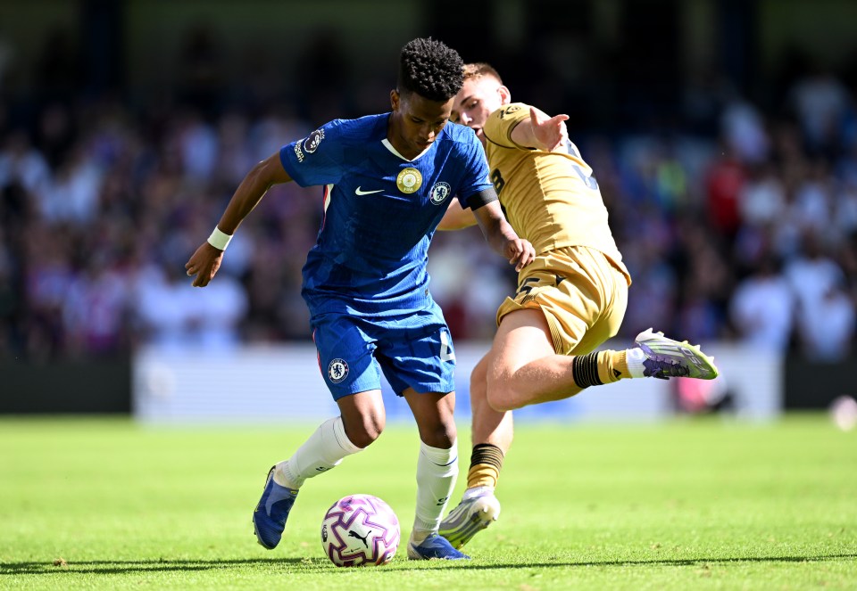 Chelsea's Estevao challenged by Crystal Palace's Justin Devenny during a Premier League match.