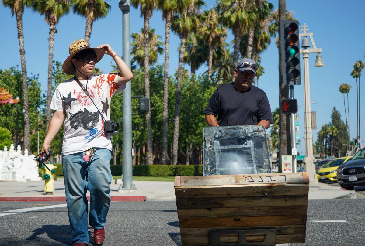 Perry Picasshoe and his father walk through downtown Riverside.
