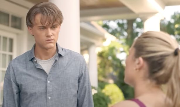 A young man talks to a woman 
