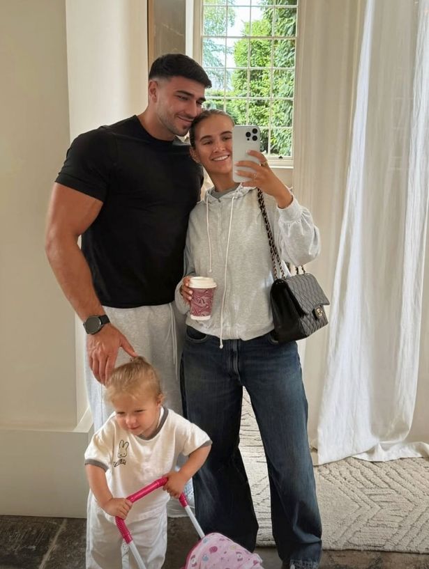 Tommy Fury and Molly-Mae Hague posing for a selfie alongside their daughter Bambi.