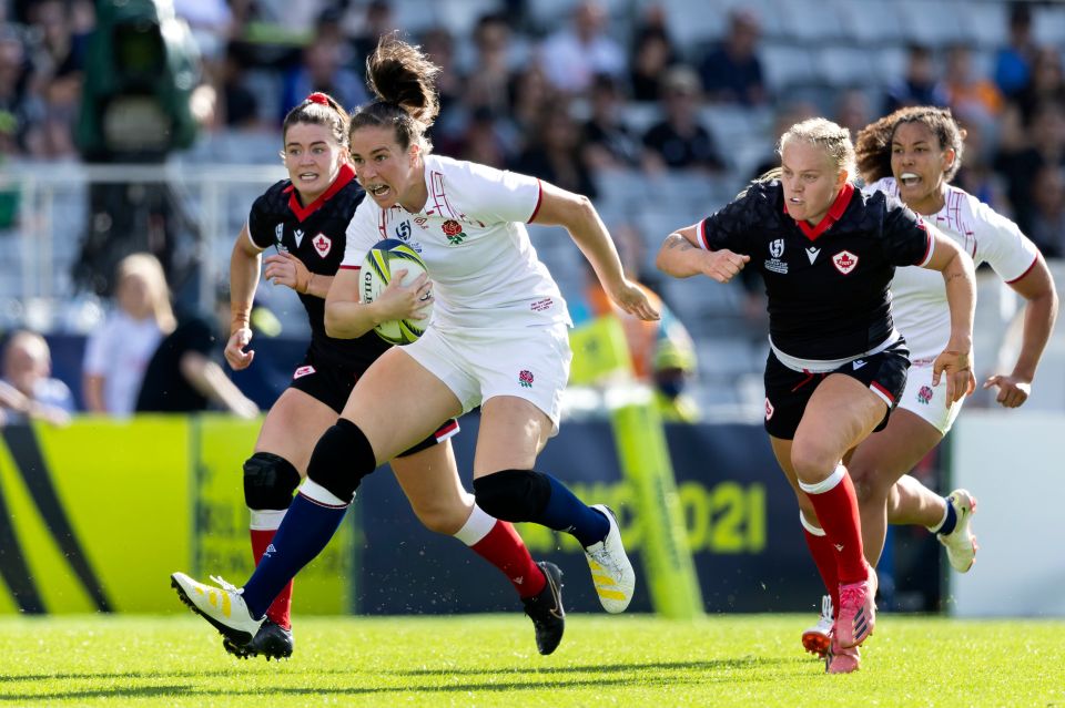 a female rugby player wearing a jersey that says ' england ' on it