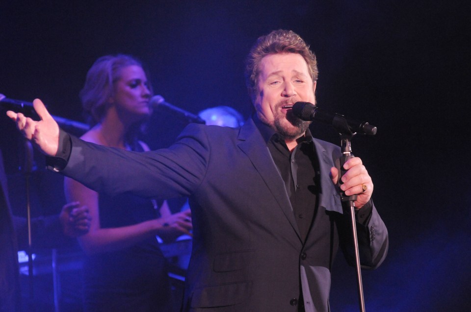 Michael Ball performing on stage.