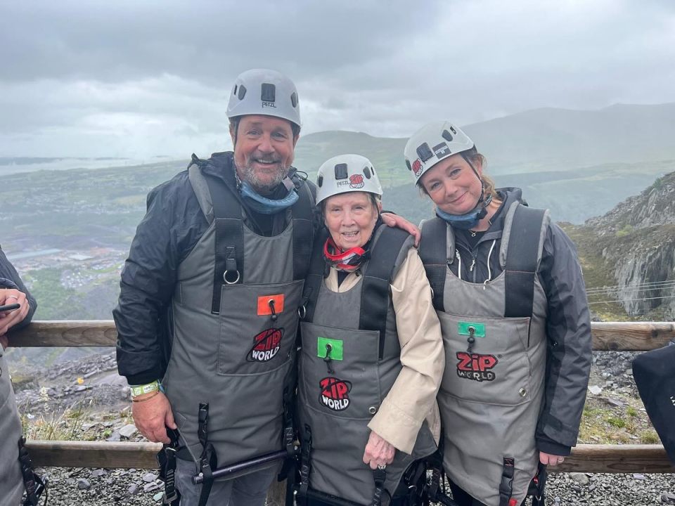 Michael Ball OBE with two women in Zip World harnesses.