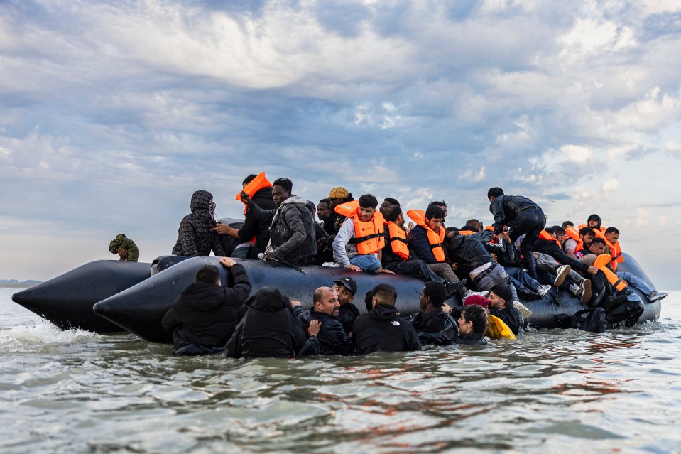 Migrants boarding a smuggler's boat.