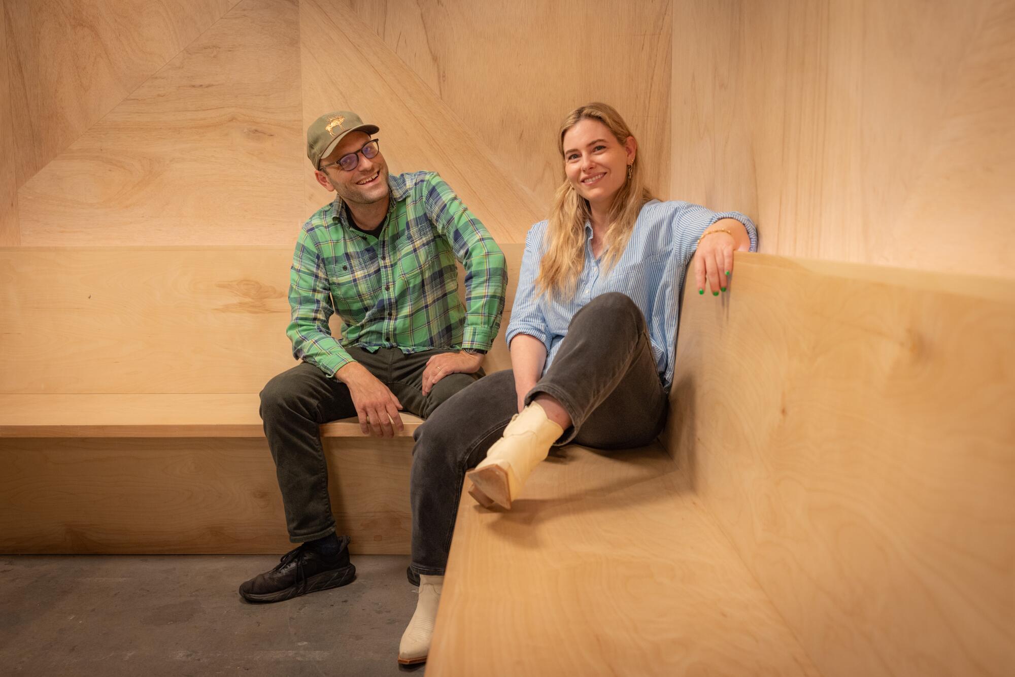 two people sitting on a bench
