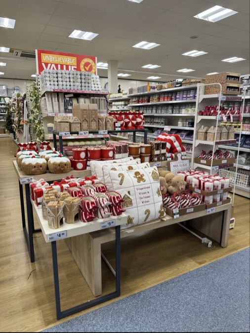 Christmas decorations and candles on display in a store.