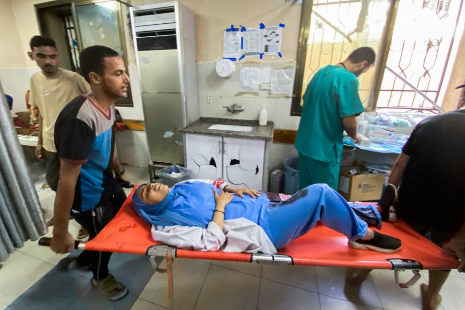 Injured woman being carried on a stretcher in a hospital.