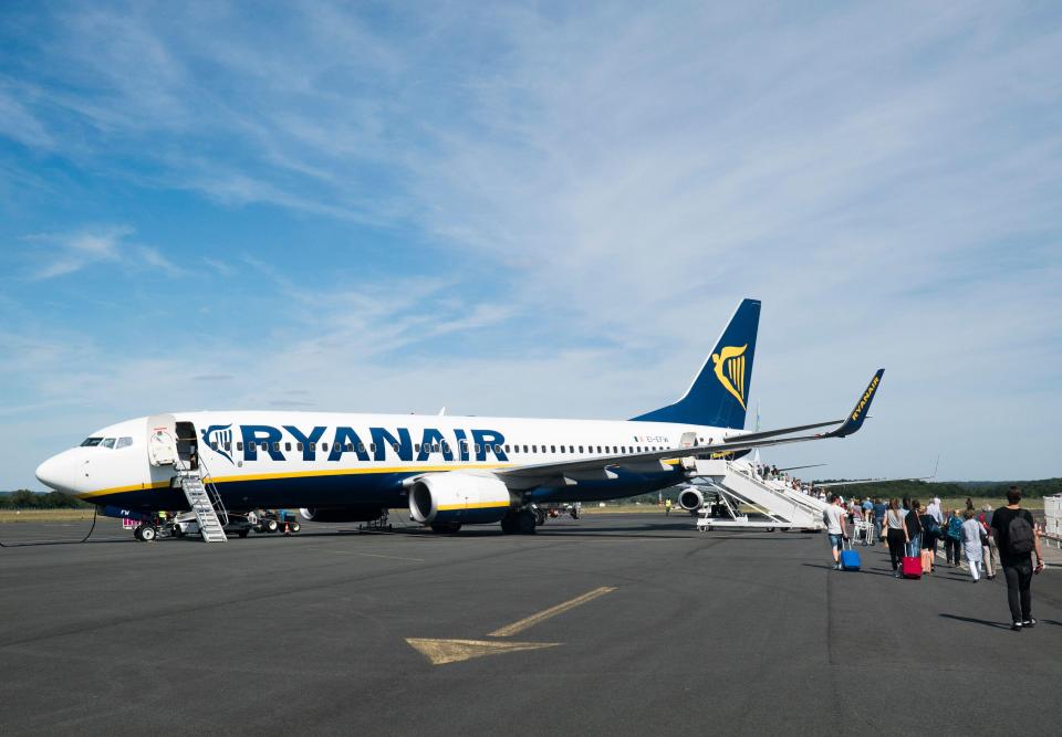 Ryanair Boeing 737-800 at Bergerac airport with passengers boarding.