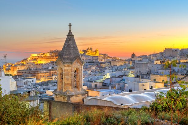 Ostuni, Italy historic town skyline in Puglia at dawn.