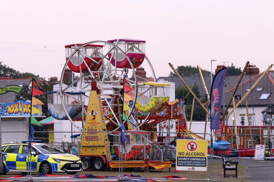 Police car and cordon around a fairground ride.