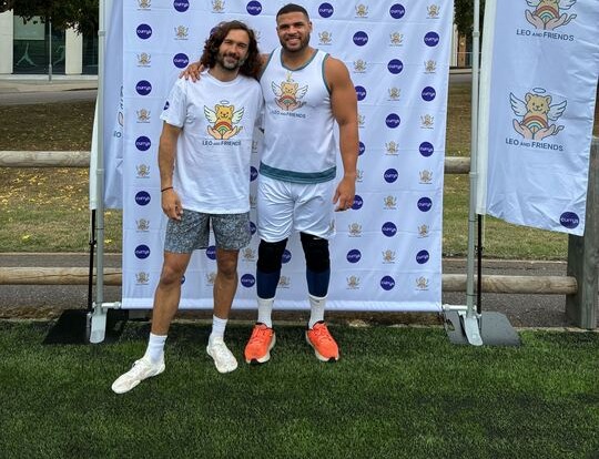 Two men posing for a photo at a charity event for Leo and Friends, a baby loss charity.
