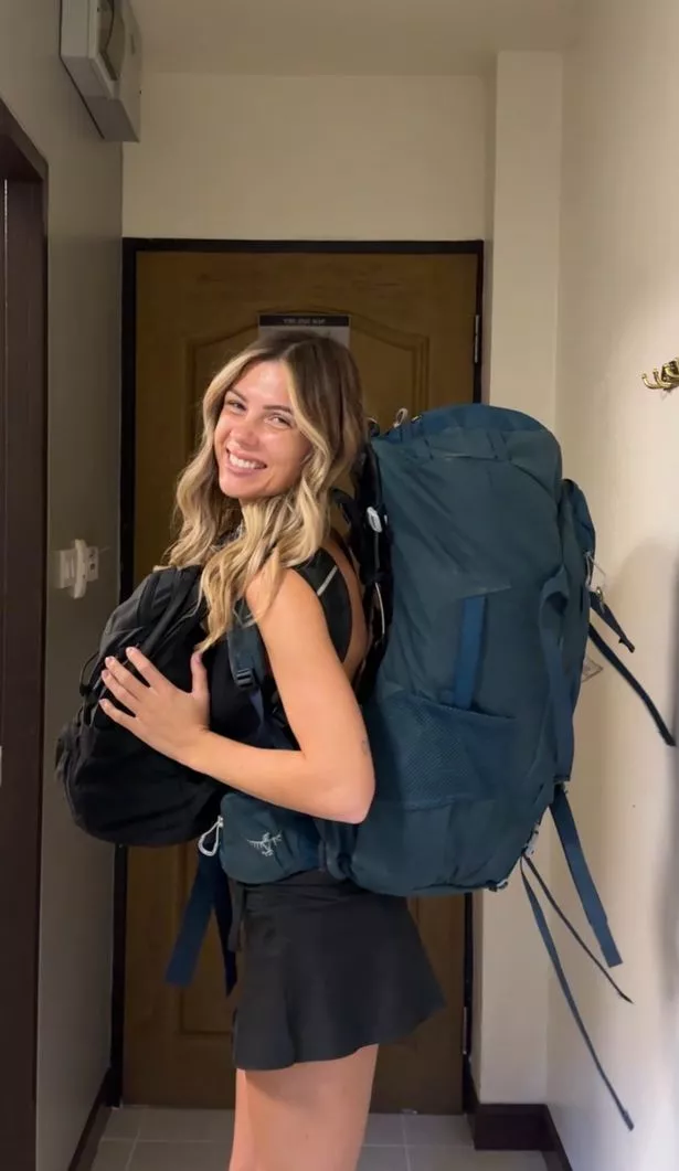 Rachel in a black outfit carrying her backpack
