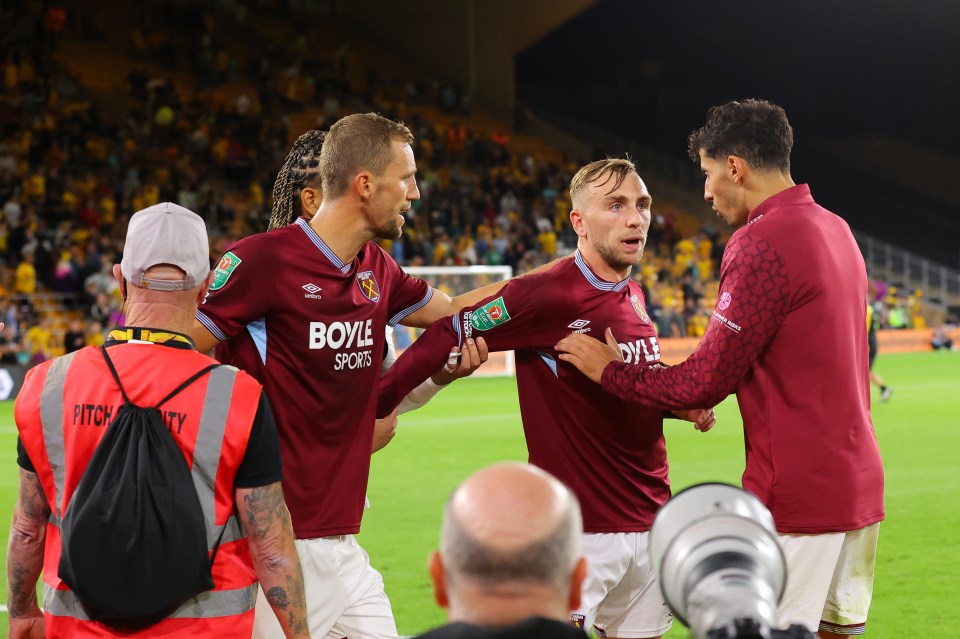 WOLVERHAMPTON, ENGLAND - AUGUST 26: Jarrod Bowen of West Ham United is pulled away after clashing with West Ham supporters after the Carabao Cup second round match between Wolverhampton Wanderers and West Ham United at Molineux on August 26, 2025 in Wolverhampton, England. (Photo by James Gill - Danehouse/Getty Images)