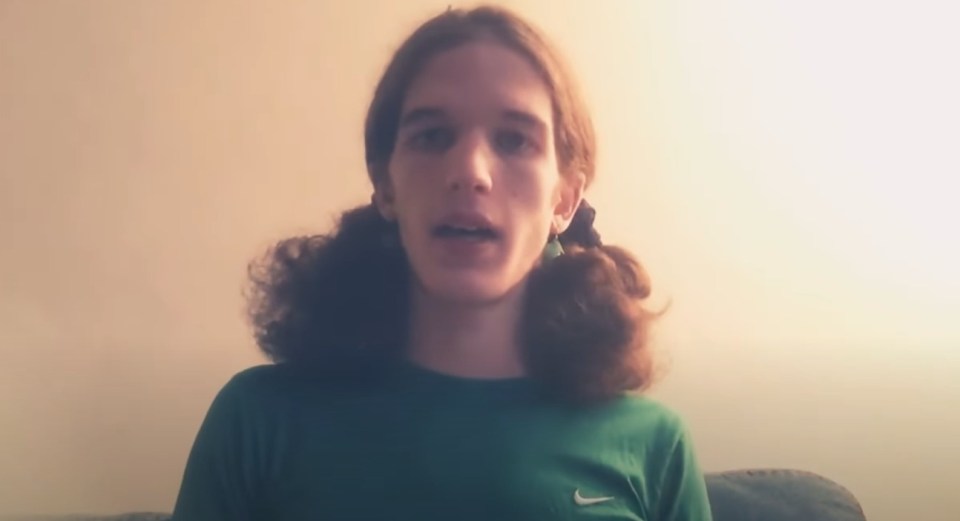Person with long brown hair in pigtails speaking to the camera.