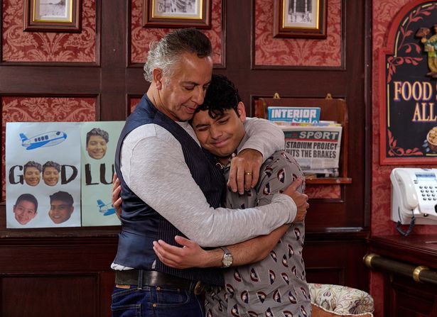 Jimmi Harkishin hugging Adam Hussain in a scene from Coronation Street.