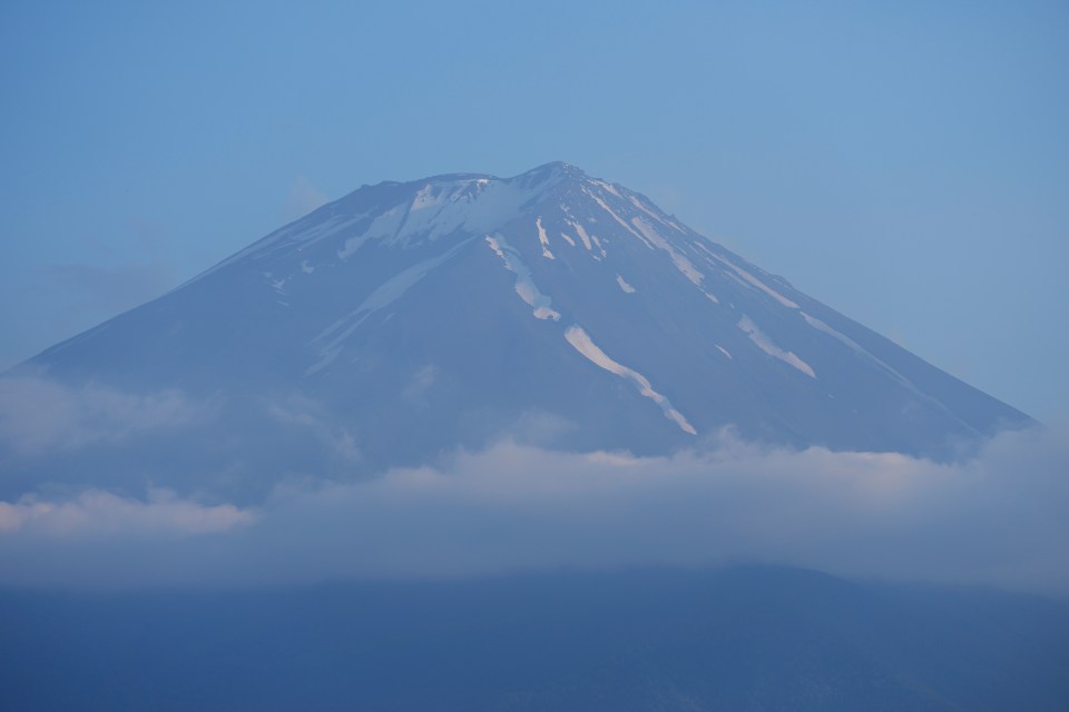 Mount Fuji partially obscured by clouds.