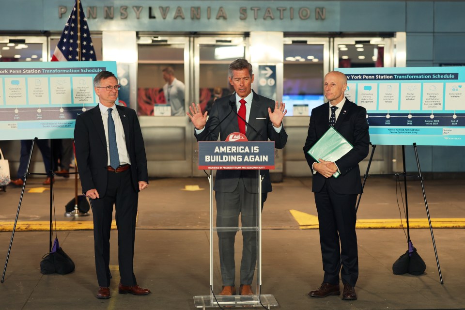 Three men in suits at a press conference announcing the New York Penn Station Transformation Project.