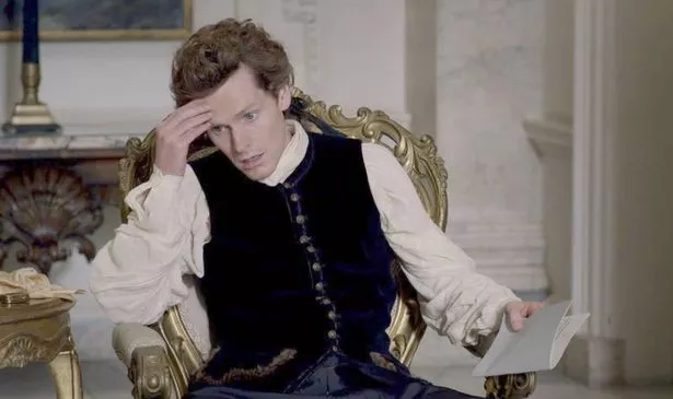 A man holds his head in his hand