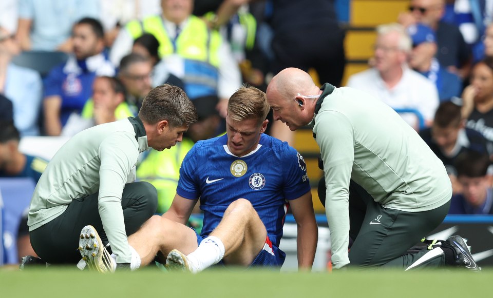 Injured Chelsea player receiving medical attention on the field.