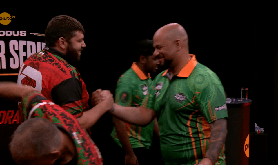 Two dart players shaking hands.