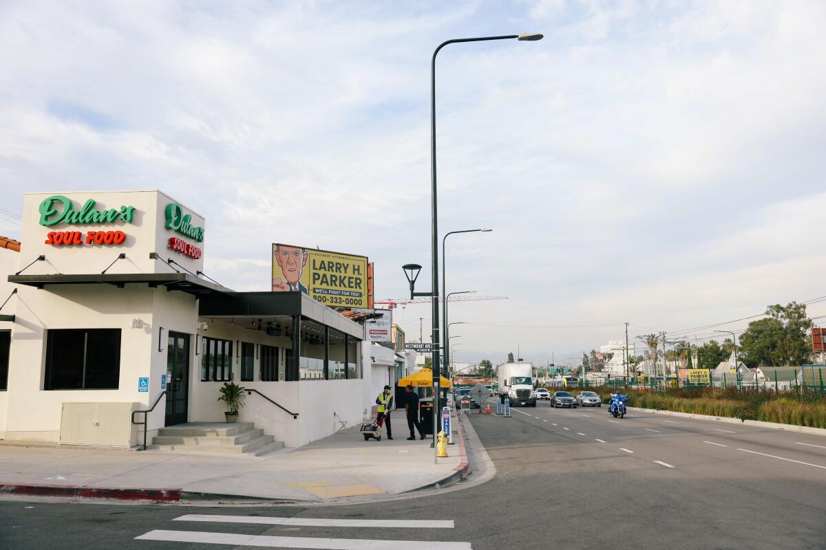 Cars pass along Crenshaw Boulevard in front of Dulan's in Los Angeles