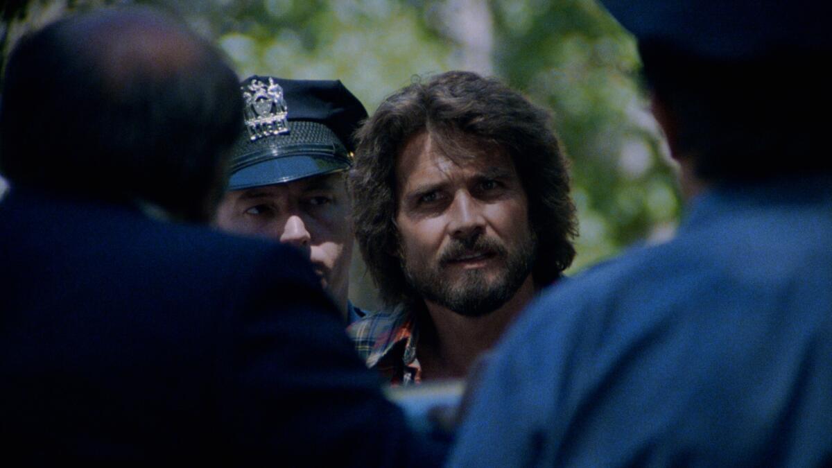 A man with a beard is surrounded by cops.