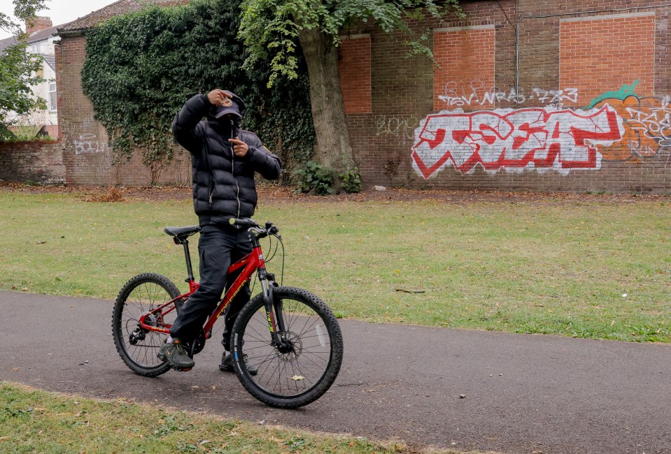 Person on a red bicycle in Ayresome Gardens, Middlesbrough.