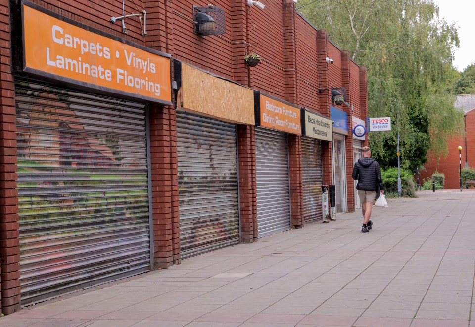 Middlesbrough street scene with closed shops and a pedestrian.