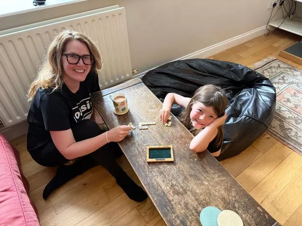 Hannah and Molly ditch the screens and play dominoes